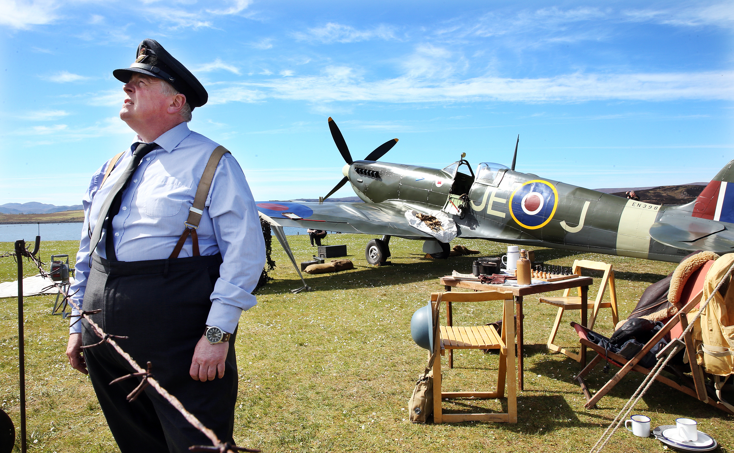 A replica Spitfire on display at the Battle of Britain camp in Aultbea, with pilot Mark Anthony Craig.